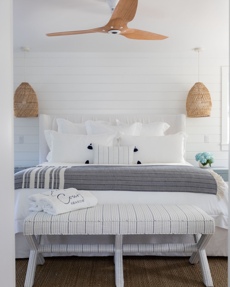 The Court guest room with embroidered towels and striped textiles